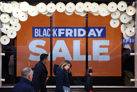 Black Friday shopping scene in London, UK with crowds of shoppers outside retail stores